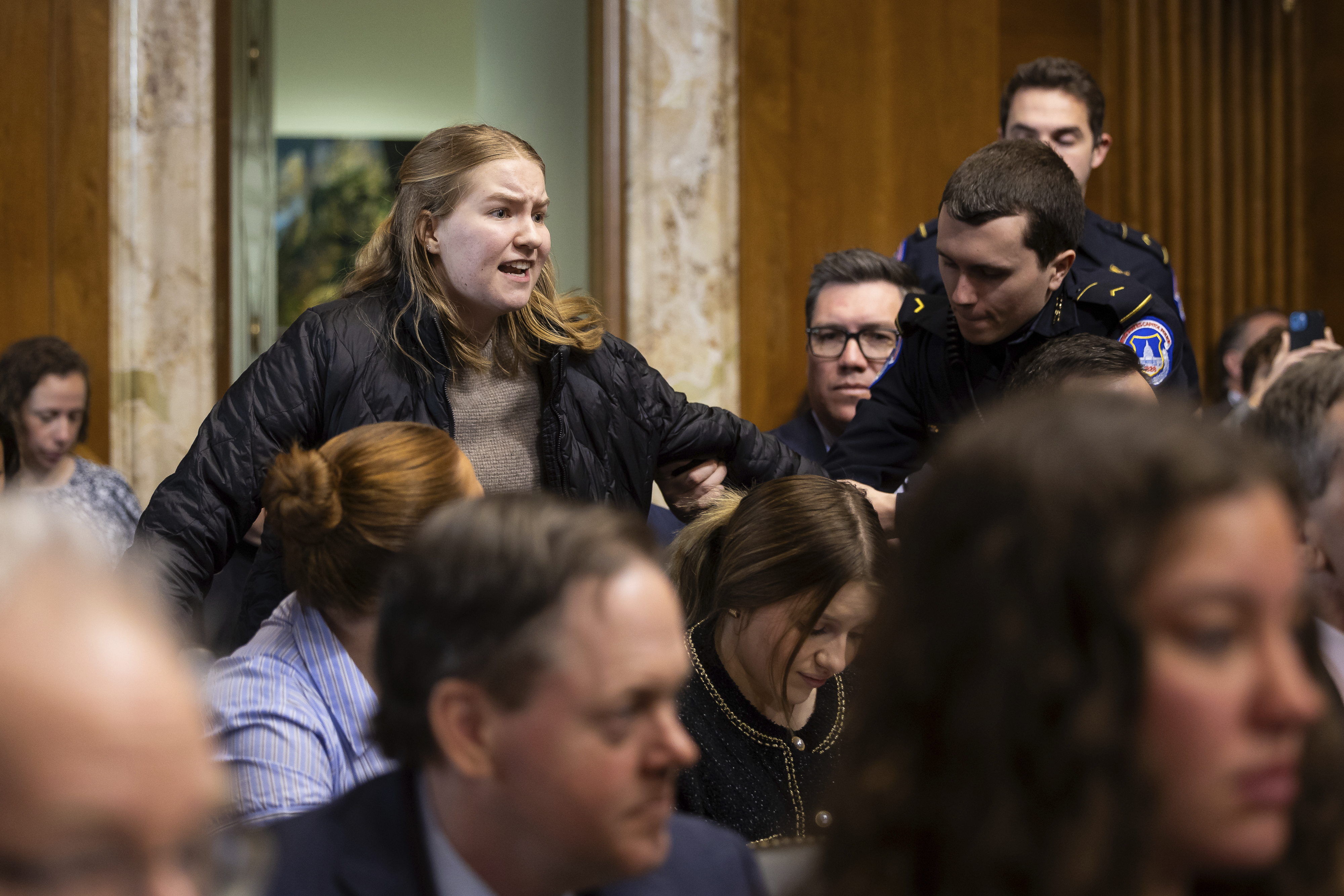 A climate protester is taken away by U.S. Capitol Police officers. A climate protester is taken away by U.S. Capitol Police officers.