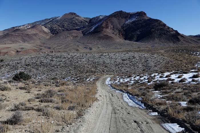 A road crosses the high desert along Rhyolite Ridge in Nevada. A road crosses the high desert along Rhyolite Ridge in Nevada.
