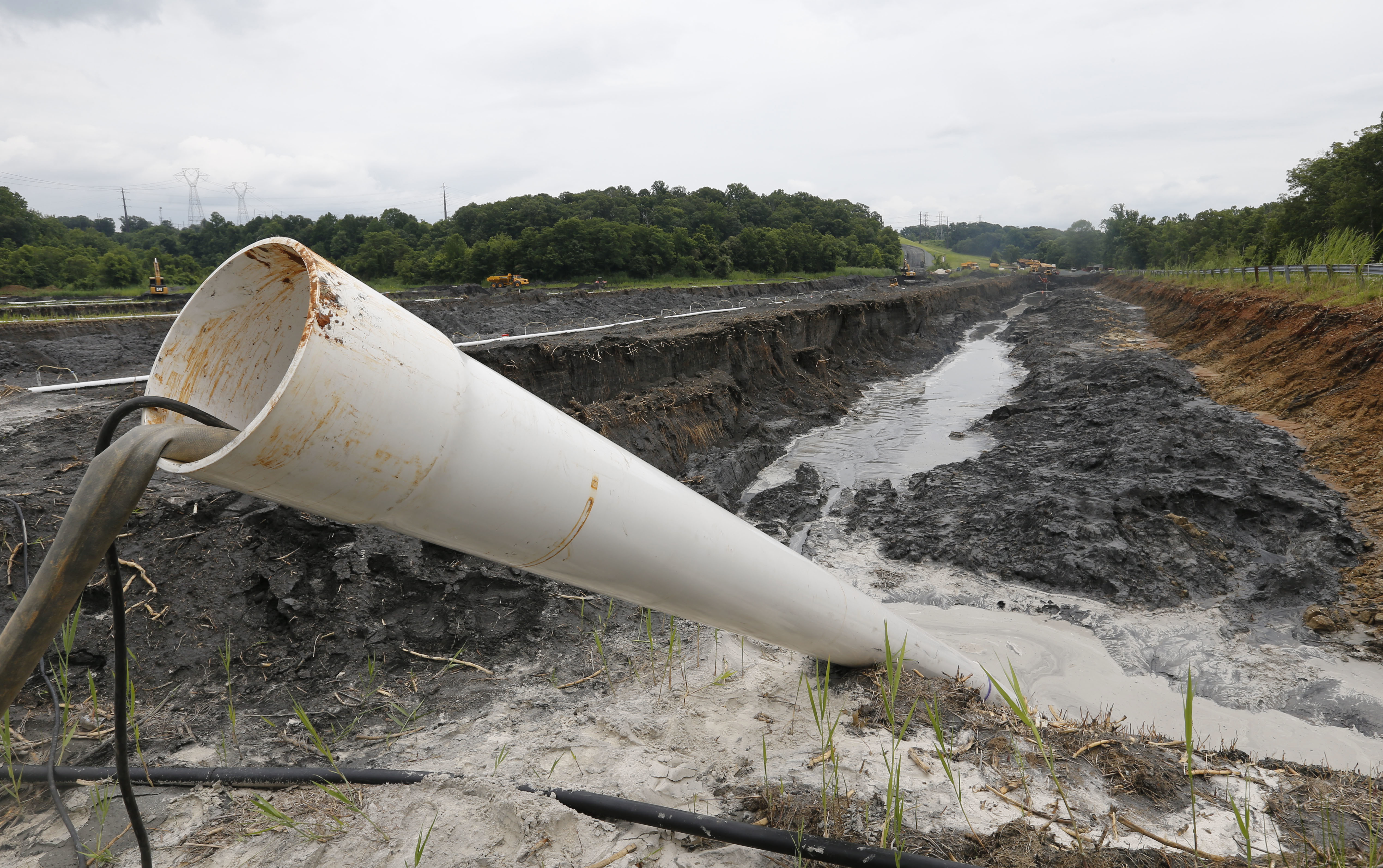 A drain pipe sticks out of a coal ash retention pond at the Dominion Power's Possum Point Power Station in Dumfries, Virginia. A drain pipe sticks out of a coal ash retention pond at the Dominion Power's Possum Point Power Station in Dumfries, Virginia.