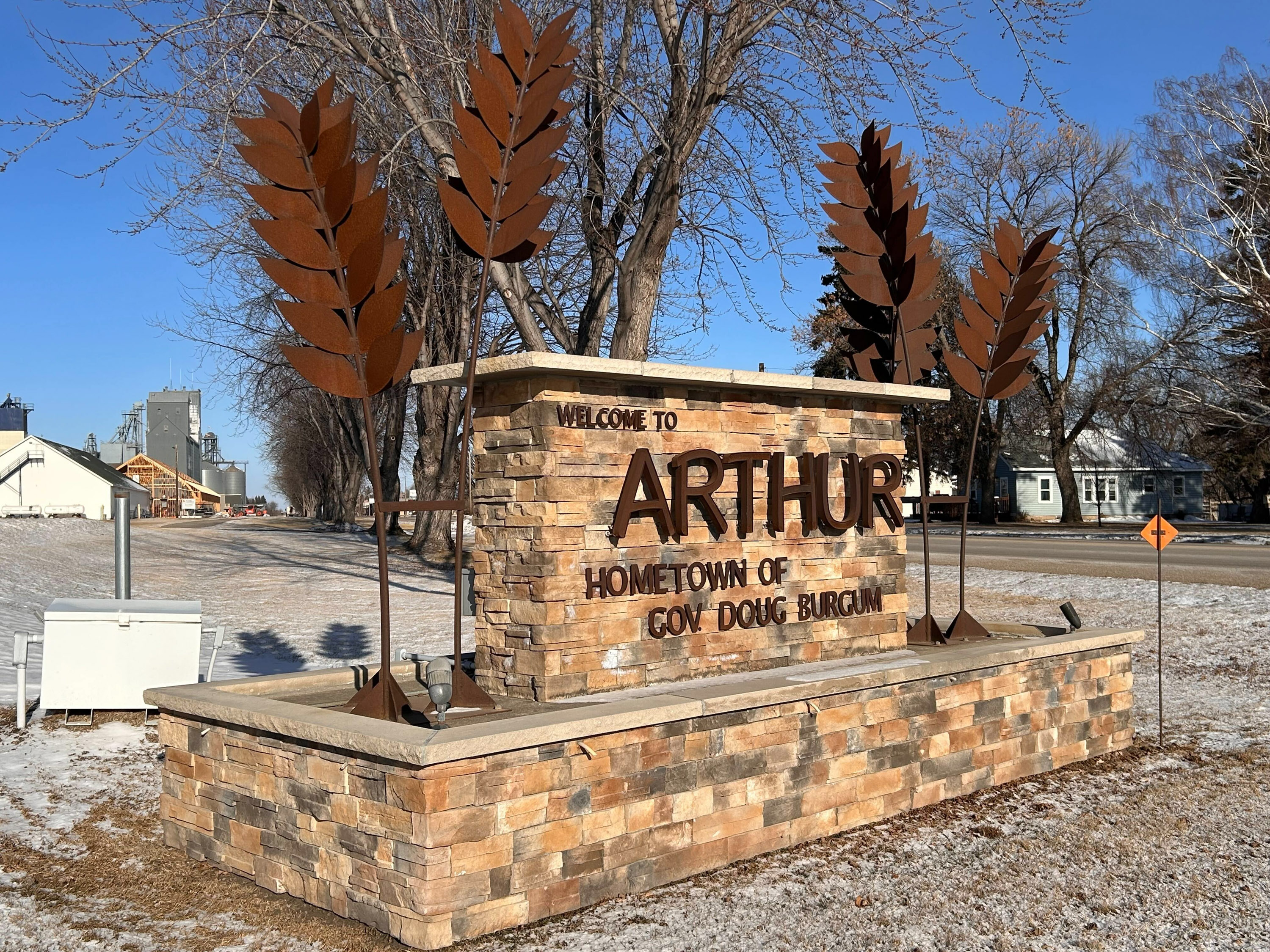 A brick sign that reads: "Welcome to Arthur, Hometown of Gov. Doug Burgum." A brick sign that reads: "Welcome to Arthur, Hometown of Gov. Doug Burgum."