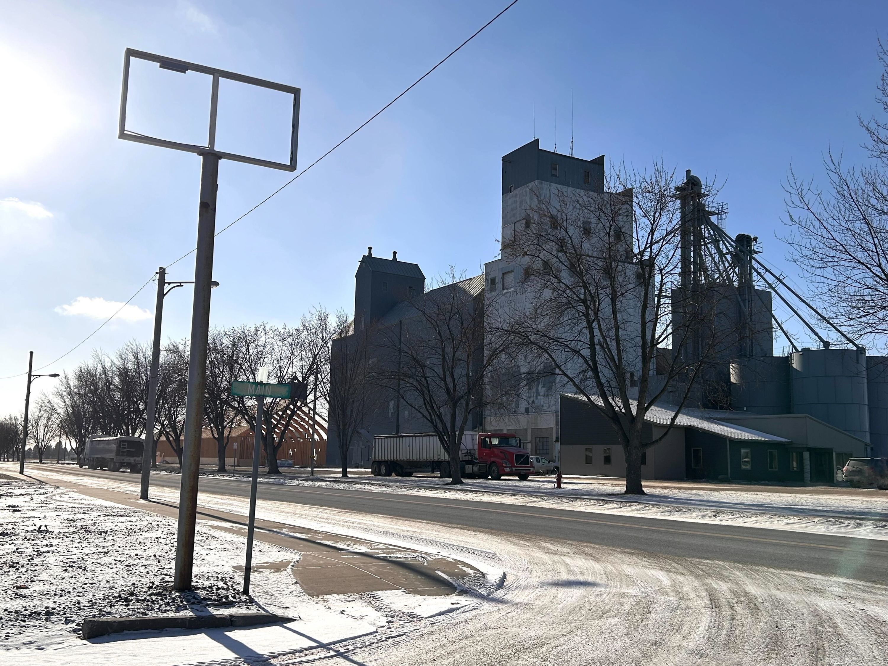 A grain elevator is seen on a snowy street. A grain elevator is seen on a snowy street.