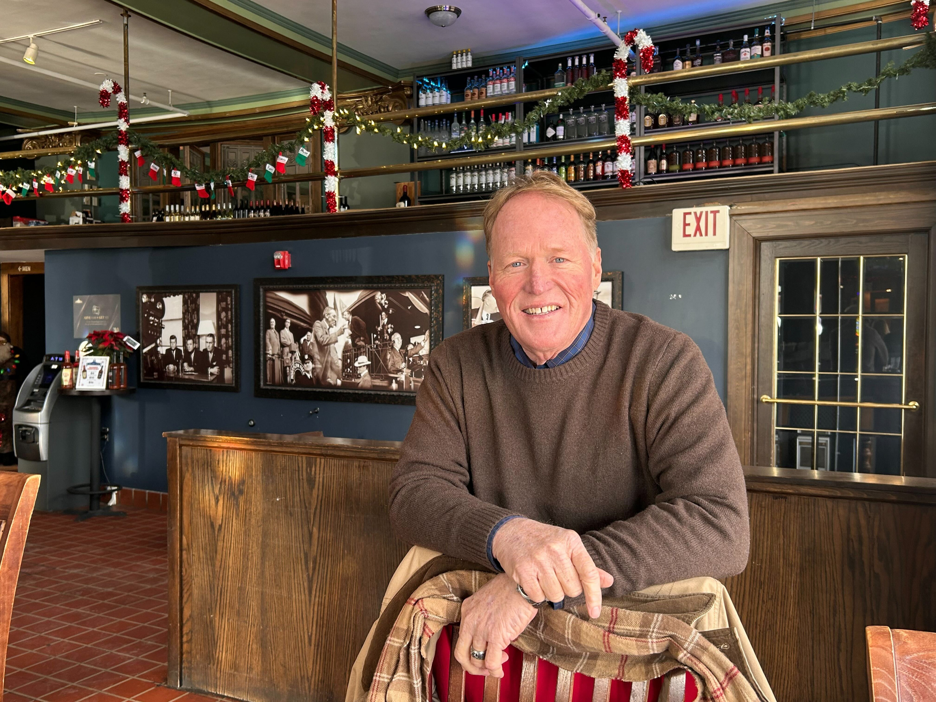Joel Heitkamp stands behind a chair at the bar. Joel Heitkamp stands behind a chair at the bar.
